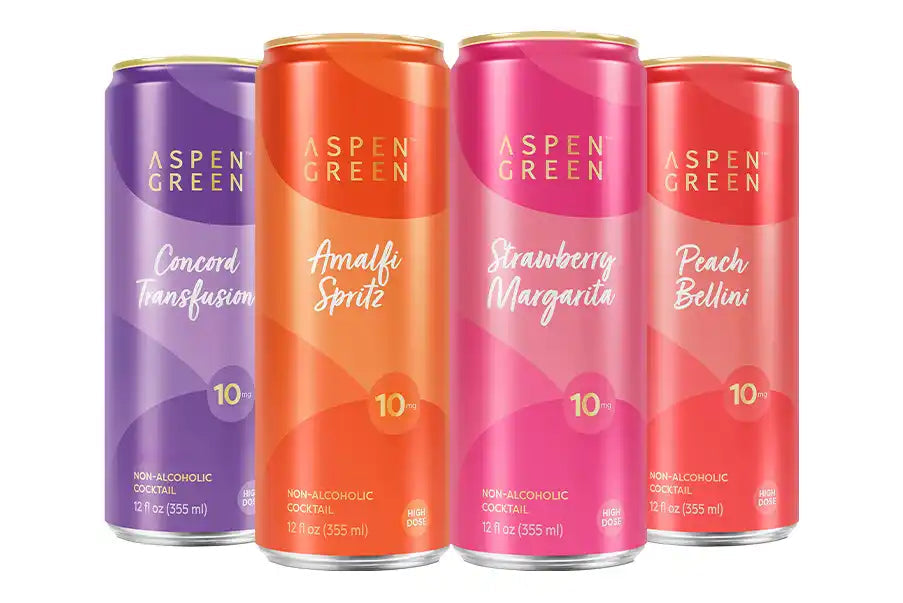Four colorful cans of Aspen Green non-alcoholic cocktails on a white background