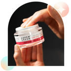 Hand grabbing Aspen Green Relief Cooling Cream from jar