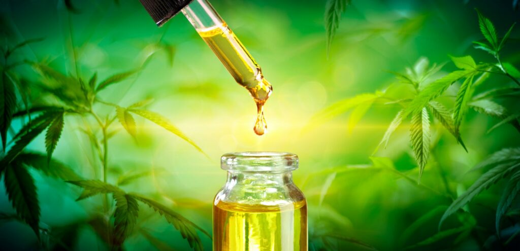 CBD Oil Dropping Into Bottle