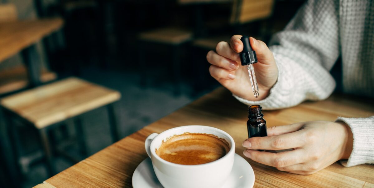 Using CBD oil in cup of coffee