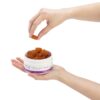 Aspen Green USDA Certified Organic CBD Gummies in open jar with hand holding gummy, Bliss (50mg CBD), Tropical Flavor