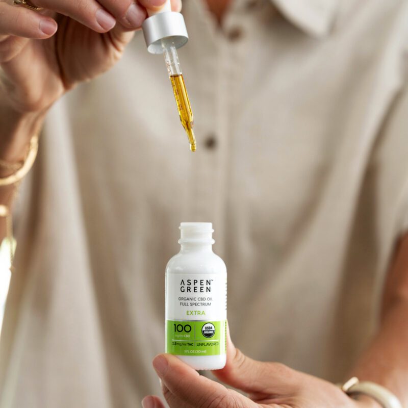 Suspended dropper of Aspen Green Extra Unflavored CBD Oil over tincture