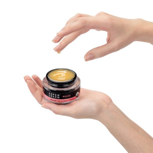 Aspen Green Rouse Full Spectrum CBD Intimacy Cream - Hand reaching for an open container
