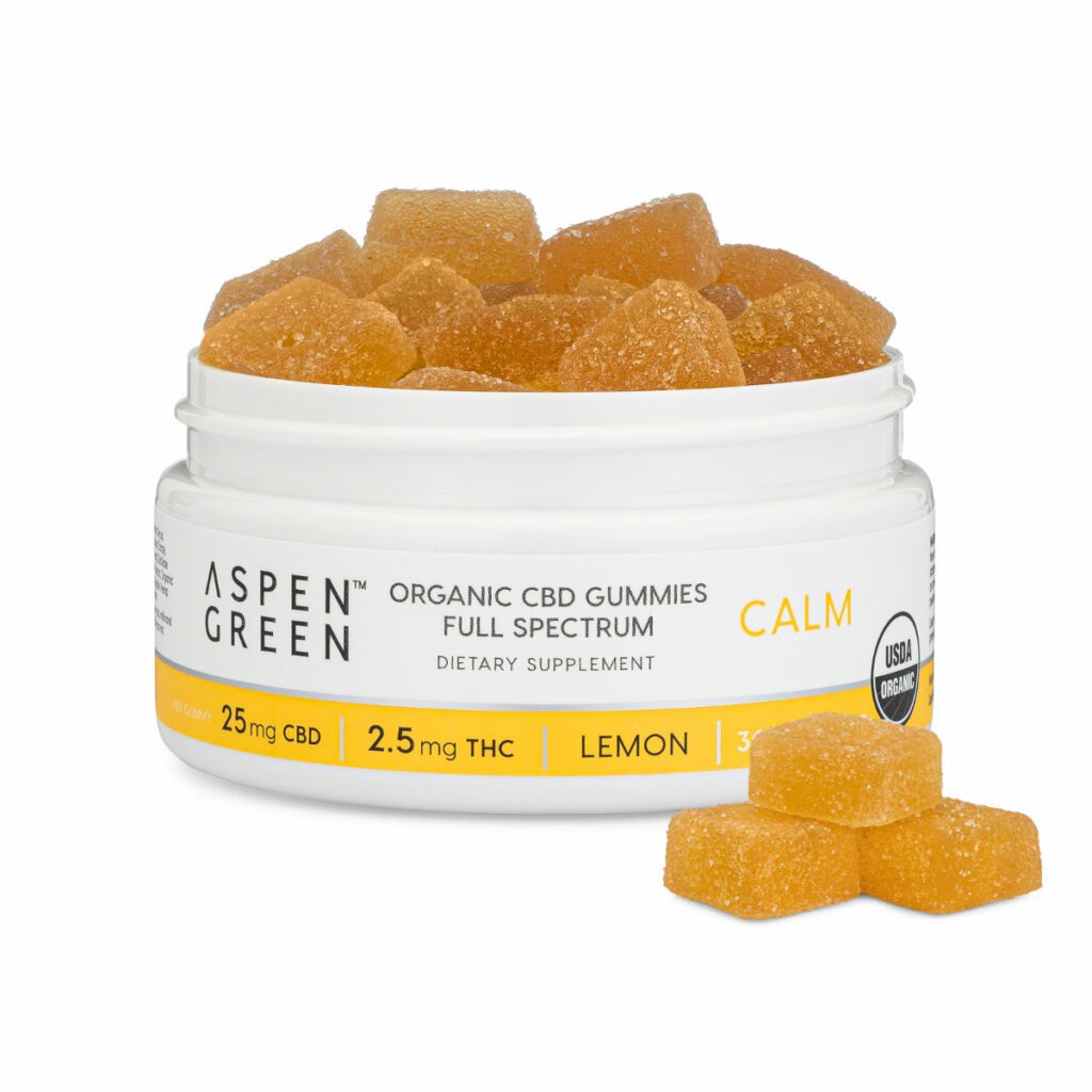Aspen Green Calm Full Spectrum CBD Gummies - Open jar revealing USDA Certified Organic, 25mg CBD accompanied by three individual gummies, Lemon Flavor, 30 count Aspen Green Calm Full Spectrum CBD Gummies - Open jar revealing USDA Certified Organic, 25mg CBD accompanied by three individual gummies, Lemon Flavor, 30 count