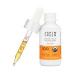 Aspen Green Extra Citrus CBD Oil tincture bottle with a dropper leaning against the bottle.