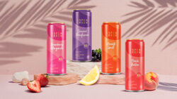 Aspen Green 10mg THC drinks 4-flavor variety pack surrounded by fresh fruit in a lifestyle setting